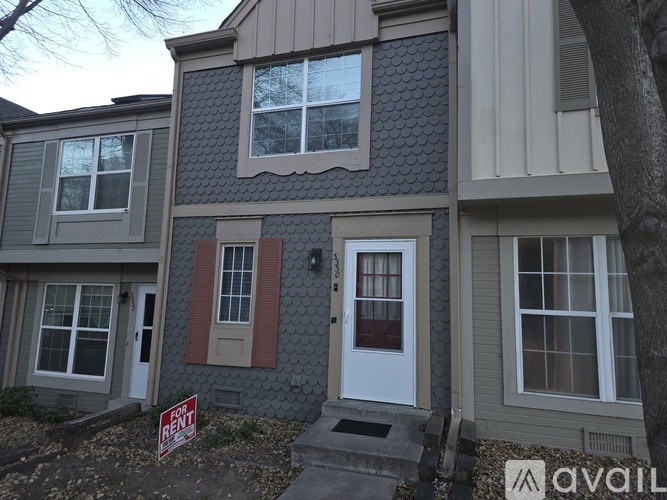 A house with a "For Sale" sign in front of it.