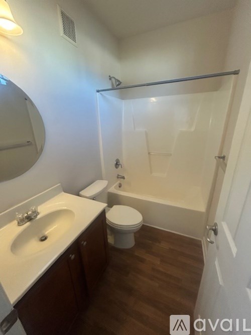 A bathroom with a toilet, sink, and bathtub.