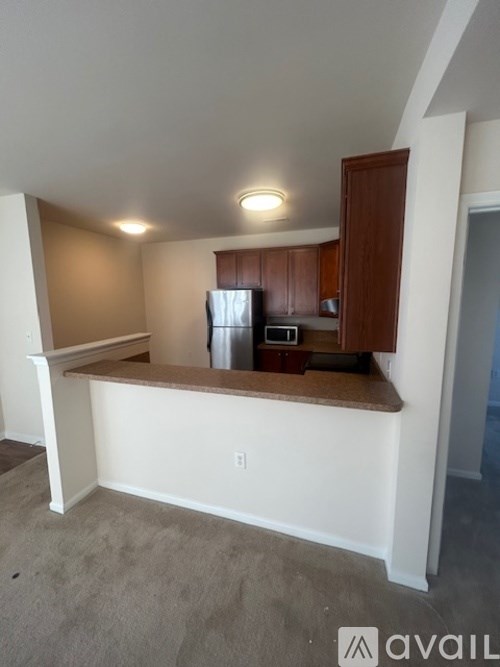 A kitchen area with a refrigerator, microwave, and oven.