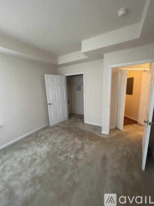 A room with a white door and a white wall.