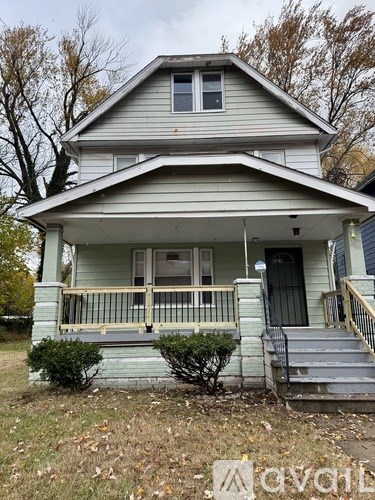 A house with a front porch and a black door.