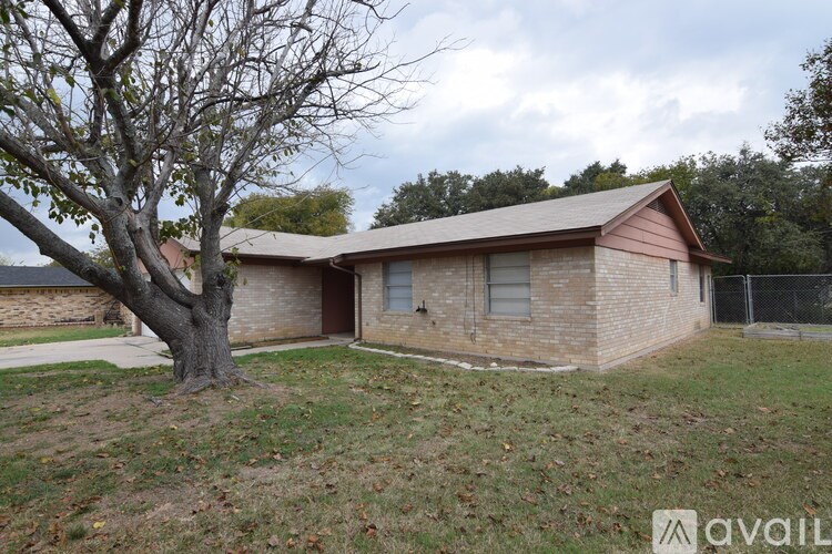 A house with a tree in front of it.