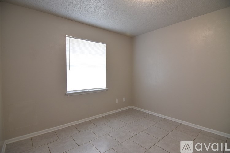 A room with a window and tiled floor.