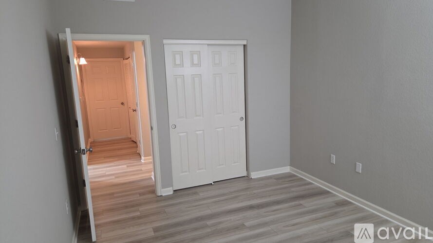 A room with a white door and a white wall.