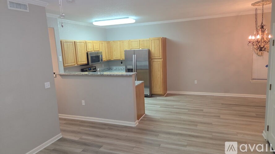 A kitchen with wooden cabinets and a countertop.