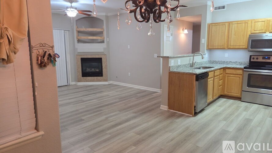 A kitchen with wooden cabinets and a stainless steel oven.