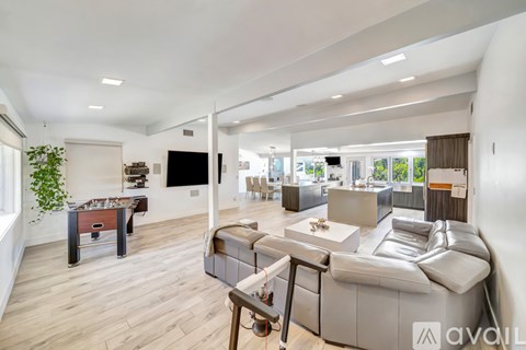 A modern living room with a large grey sofa and a wooden coffee table.