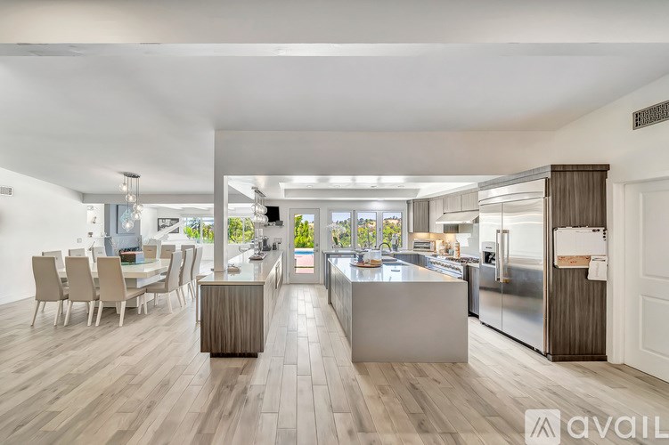 A modern kitchen with a dining table and chairs.