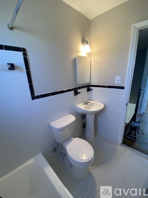 A white toilet and sink in a bathroom.