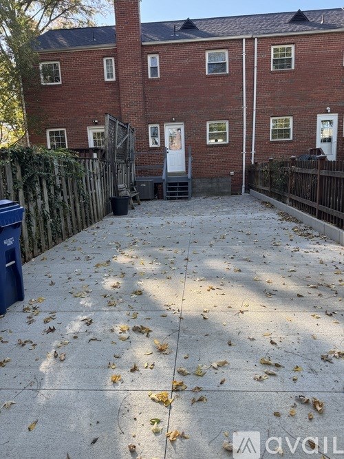 A red brick building with a white door and windows.