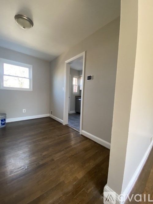 A room with wooden floors and a window.
