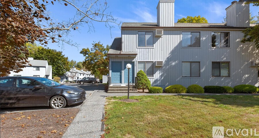 A modern house with a car parked in front.