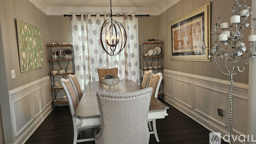 A dining room with a table set for four.