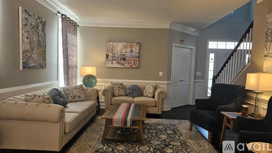 A living room with a couch, chair, and a coffee table.