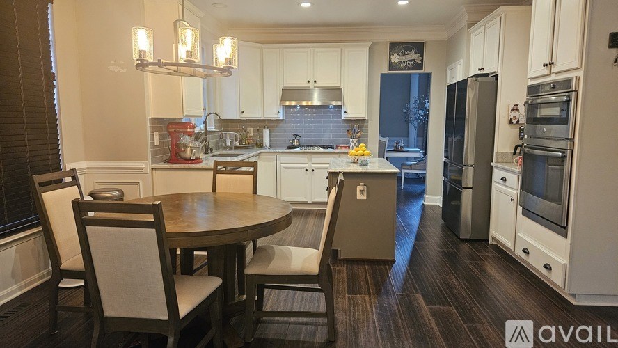 A kitchen with a table and chairs in the middle of the room.