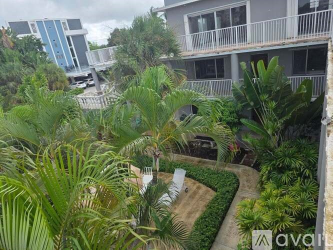 A balcony overlooks a landscaped courtyard.
