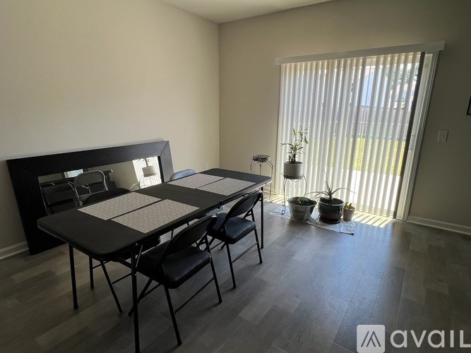 A dining room with a table and chairs.