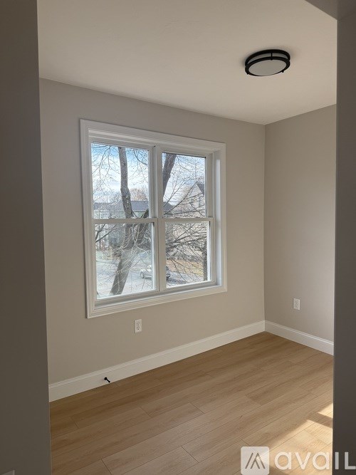 A room with a window showing a snowy landscape outside.