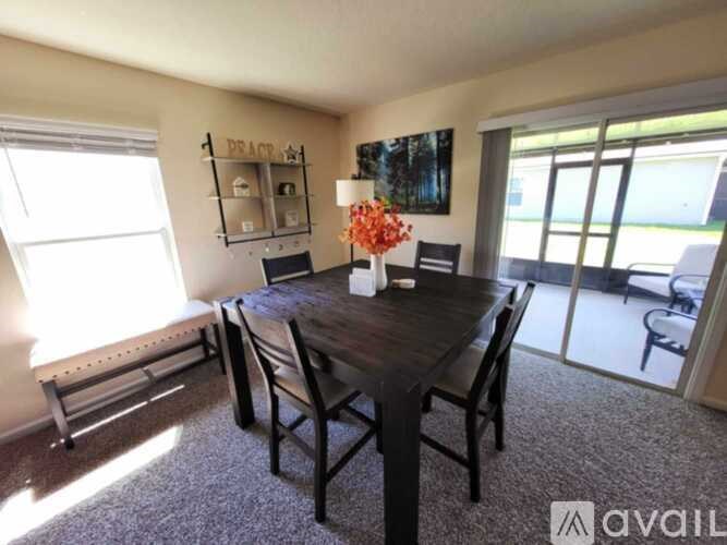 A dining room with a wooden table and chairs.