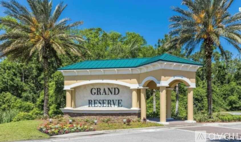 A building with the words "Grand Reserve" on it is surrounded by palm trees.