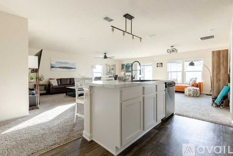 A modern kitchen with white cabinets and a large island.
