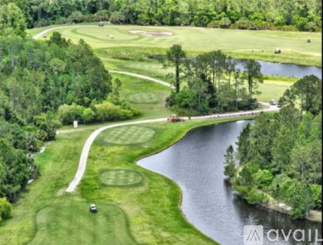 A golf course with a pond and a bridge.