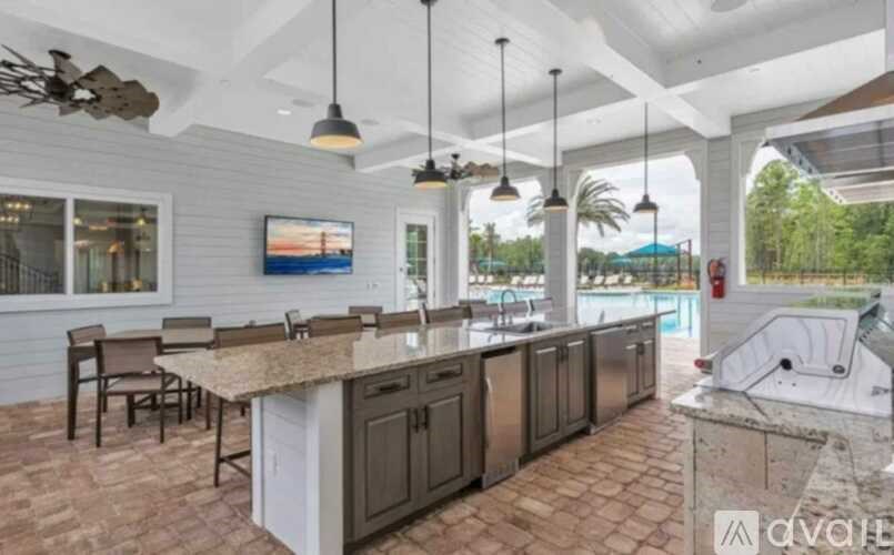 A kitchen with a bar area and a television mounted on the wall.