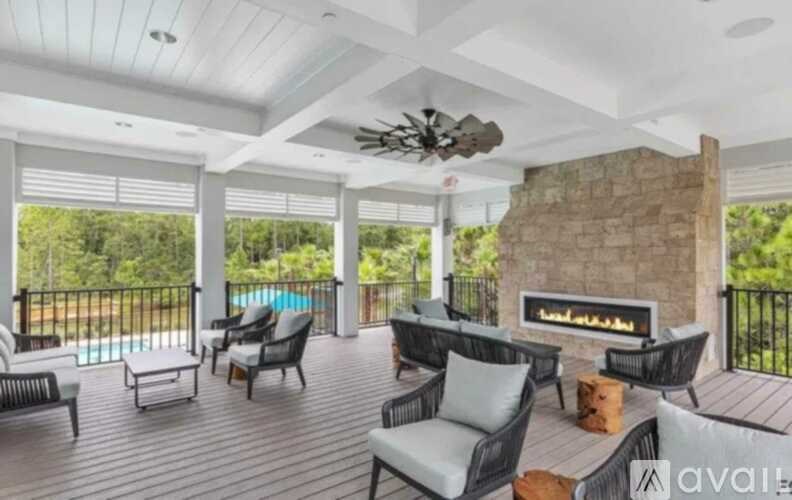 A patio with a fireplace and chairs.