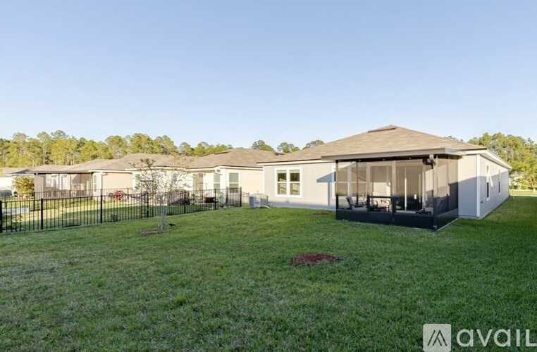 A house with a fenced yard is available for sale.