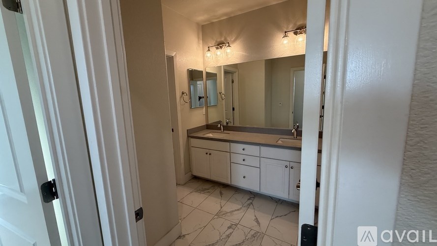 A bathroom with a vanity and a mirror.