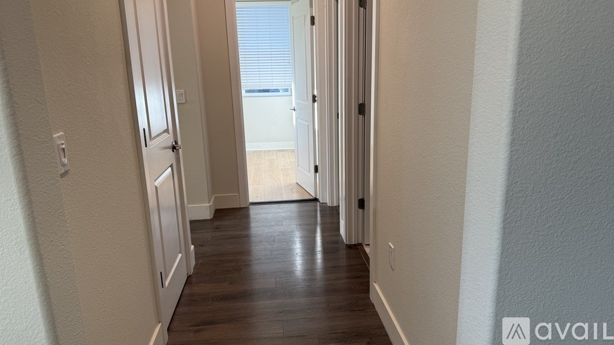 A long hallway with doors on both sides.