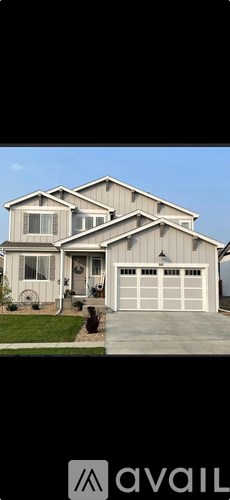A large, two-story house with a garage is available for sale.