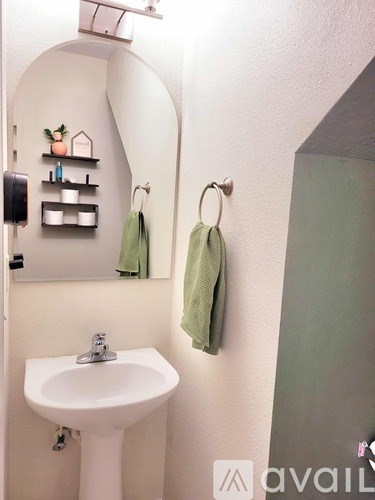 A bathroom with a white sink and a mirror.