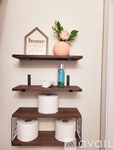 A shelf with a sign that says home is the best place to be.