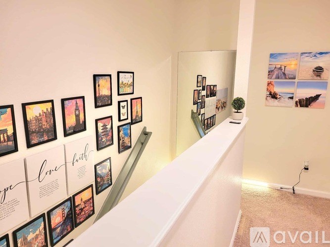 A wall of framed pictures with the word "love" written on the bottom left.