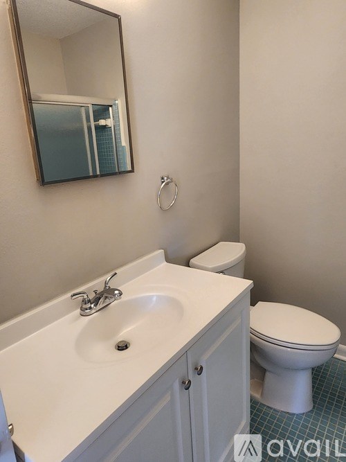 A white sink and toilet in a bathroom.