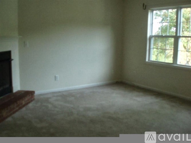 A room with a fireplace and a window.
