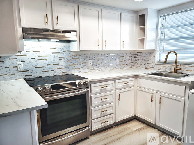 A kitchen with a stove top oven and a sink.