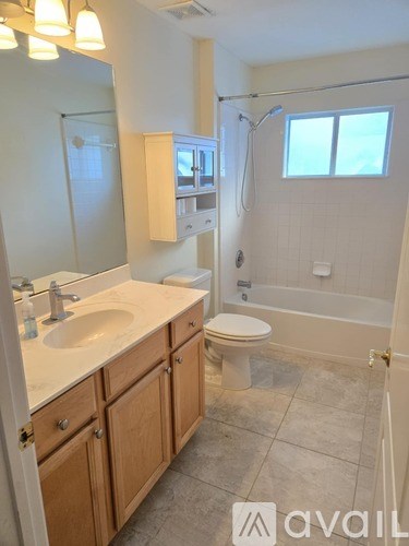 A bathroom with a sink, toilet, and bathtub.