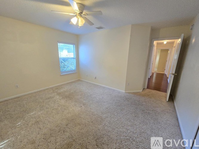 A room with a ceiling fan and a window.