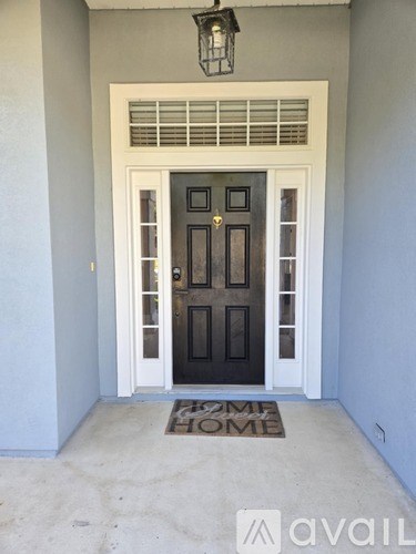 A black door with a glass panel and a white door frame.