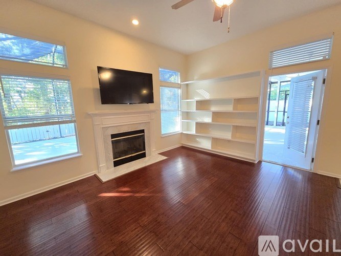 A living room with a fireplace and a television.