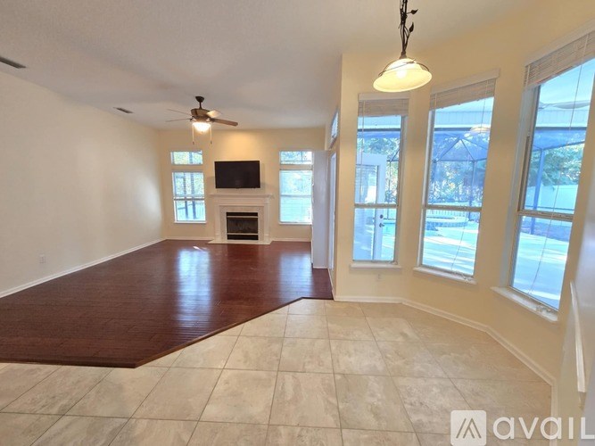 A living room with a fireplace and a flat screen TV.