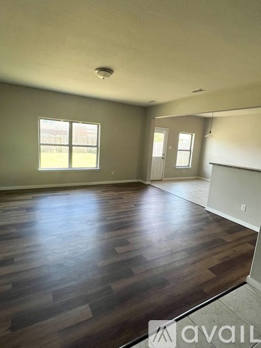 A room with wooden floors and a window.