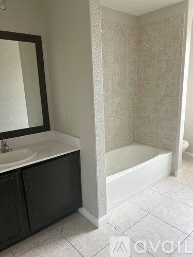 A bathroom with a white tub and a sink.