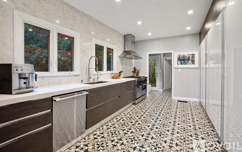 A kitchen with a patterned floor and a large island.