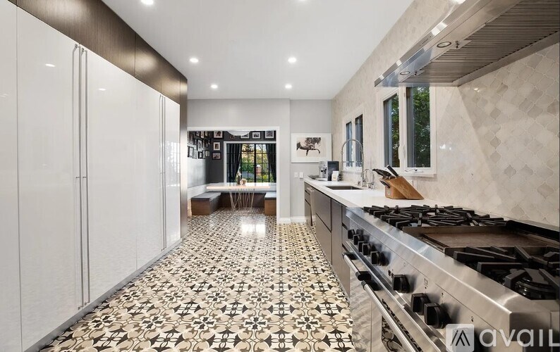 A kitchen with a black and white floor.