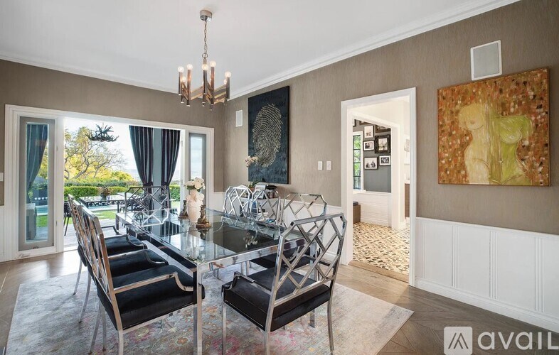 A dining room with a glass table and chairs.