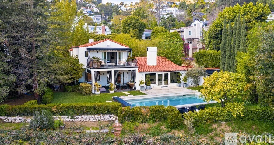 A large house with a pool in the backyard.