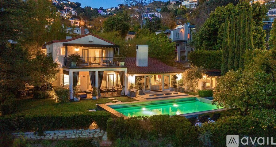 A house with a pool in the backyard is available for sale.